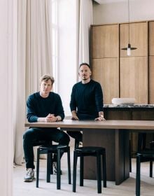 Linen book cover of Morph?, Van Damme - Vandeputte Architects, with an Interior space with low black coffee-table, white bust sculpture on plinth, wood chair, and white marble fireplace. Published by Luster Publishing.