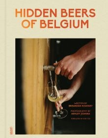 Book cover of Hidden Beers of Belgium, with a hand holding a glass under beer barrel with flowing pale liquid. Published by Luster Publishing.