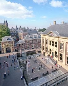 Book cover of Pen Meets Paint, 200 Years Mauritshuis, 200 Writers, 200 Paintings, with a reflection of historical building in river. Published by Waanders Publishers.