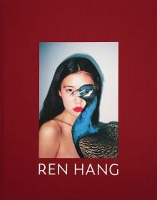 Book cover of Ren Hang: For My Mother, featuring a portrait of a nude female, with blue peacock obscuring her body. Published by Hopper&Fuchs.