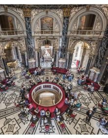 Art museum with statues in front, on cover of 'Kunsthistorisches Museum Vienna, The Official Museum Book', by Hannibal Books.