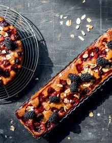 Book cover of The Home Baking Book: Timeless Recipes for Artisanal Treats, with a table of bread, pastries, cakes and tarts. Published by Hannibal Publishers.